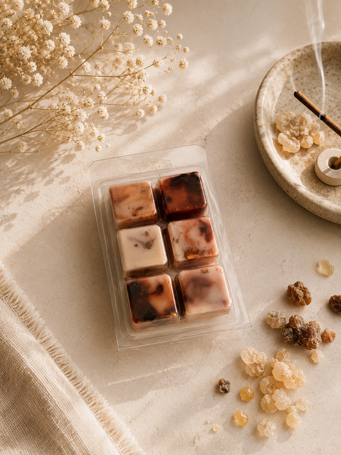 Tableta de 6 cubitos de wax melts de incienso con aroma amaderado y cálido sobre mesa decorada